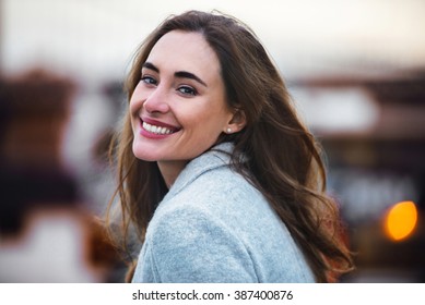 Close-up Portrait Of Beautiful Caucasian Woman With Charming Smile Walking Outdoors