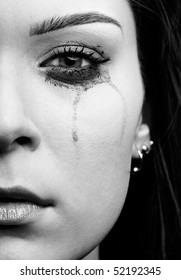 Close-up Portrait Of Beautiful Crying Girl With Smeared Mascara