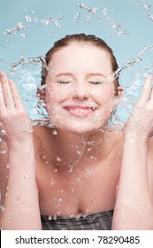 Close-up Portrait Of Beautiful Emotional Woman Washing Her Face