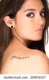 Closeup Portrait Of Beautiful Girl With Faith Tatoo On Her Back Isolated On White