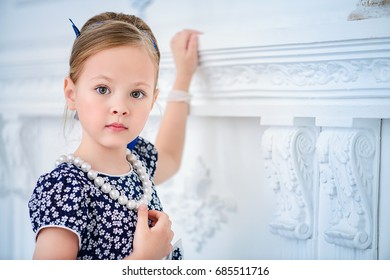 Close-up Portrait Of A Beautiful Little Girl With Elegant Hairstyle. Kid's Fashion.