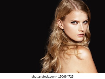 Close-up Portrait Of Beautiful Model With Long Blond Hair On Black Background