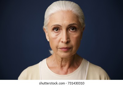 Close-up Portrait Of Beautiful Old Woman, Over Dark Blue Background