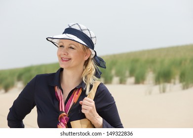 Closeup Portrait Of A Beautiful Older Woman Smiling At The Beach