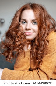 Close-up portrait of beautiful redhead woman at home