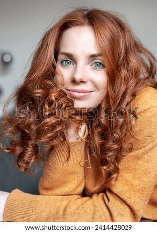 Close-up portrait of beautiful redhead woman at home