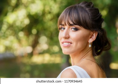 closeup portrait of beautiful smiling bride outdoors
