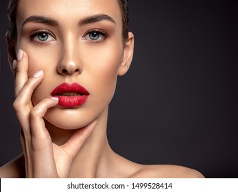 Closeup portrait of beautiful woman with bright make-up and red lips. Attractive model with a red lipstick.