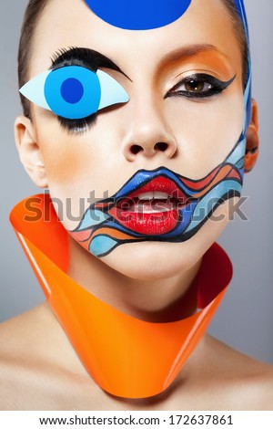 Closeup portrait of beautiful woman with painted art makeup and carnival decoration. Natural beauty, clean fresh skin. Looking at camera. Inside
