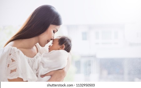 Closeup portrait of beautiful young asian mother day kissing her newborn baby. Healthcare and medical Indian hispanic family love lifestyle asia mother’s day concept panoramic banner