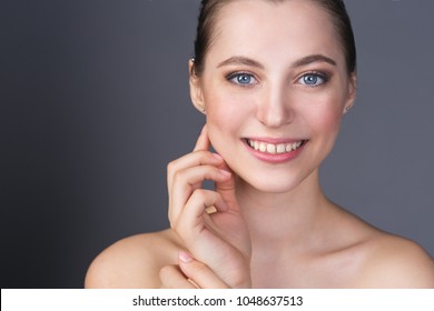 Close-up portrait of a beautiful young blue-eyed girl face
