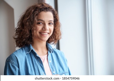 Close-up portrait of beautiful young Hispanic woman in casual clothes and looking at camera. Attractive young millennial student woman freelancer looking at camera, posing for photo.