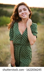 Close-up Portrait Of A Beautiful Young Smiling Woman On The Sun Set In Summer.