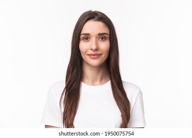 Close-up Portrait Of Beautiful Young Woman, Modern Girl With Long Chestnut Hair And No Pimples, Standing Simple Shirt And Smiling Camera, Positive Friendly Expression, White Background