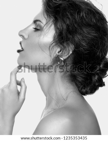 Close-up portrait of beautiful young woman with gorgeous hair black and white profile