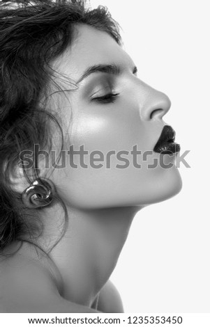 Close-up portrait of beautiful young woman with gorgeous hair black and white profile