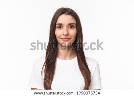 Close-up portrait of beautiful young woman, modern girl with long chestnut hair and no pimples, standing simple shirt and smiling camera, positive friendly expression, white background