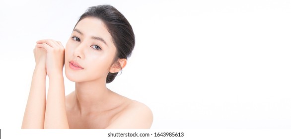 Closeup portrait of beauty asian woman with fair perfect healthy glow skin hand touch shoulder copy space, young beautiful asia girl with pretty smile on face. Beauty korean clinic skincare banner