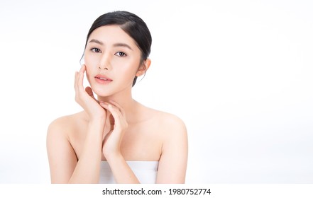 Closeup Portrait Of Beauty Asian Woman With Fair Perfect Healthy Glow Skin Hand Touching Cheek Isolated On White, Young Beautiful Asia Girl With Pretty Smile On Face. Beauty Korean Spa Skincare Banner