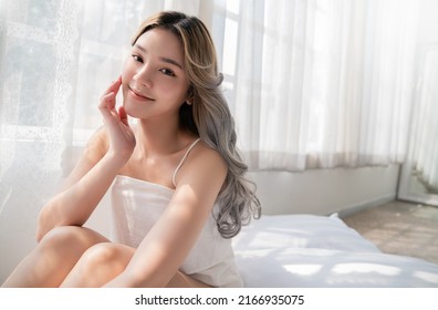 Closeup portrait of beauty asian woman with fair perfect healthy glow skin hand touching cheek chin copy space, young beautiful asia girl with pretty smile face Beauty korean women spa skincare banner