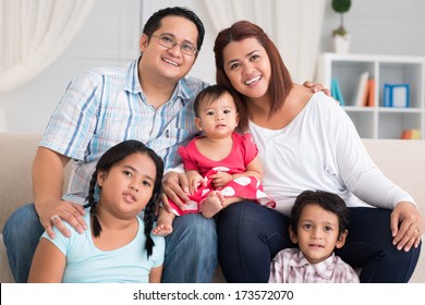 Close-up portrait of a big friendly family smiling and looking at camera 