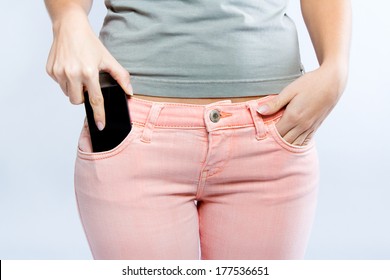 close-up portrait of Black smartphone in front pocket of girl's jeans