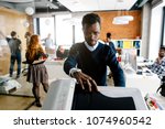 closeup portrait of black worker is printing a file , document in the office room. Accounting concept