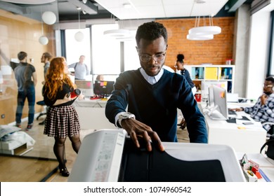 closeup portrait of black worker is printing a file , document in the office room. Accounting concept