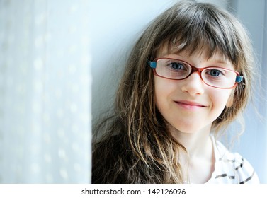 Close-up Portrait Of Brunette Child Girl In Glasses