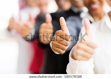 closeup portrait of business people giving thumbs up