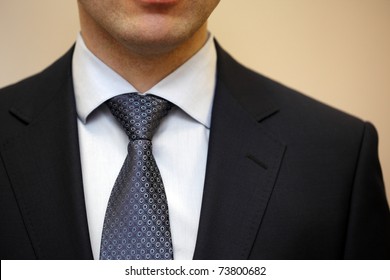 Closeup Portrait Of Businessman In White Collar Shirt And Suit With Tie.