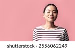 Closeup Portrait Of Calm Asian Woman Standing With Closed Eyes On Pink Background, Pleased Millennial Korean Female In Striped Shirt Feeling Relaxed And Happy While Posing In Studio, Copy Space