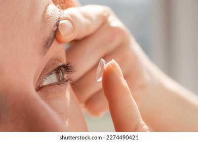 Close-up portrait caucasian woman putting on a contact lens.  - Shutterstock ID 2274490421