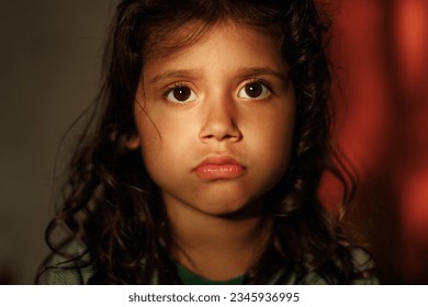 Close-up portrait of a charming 5 year old girl. The child looks sadly at the camera. girl with dark eyes and hair - Powered by Shutterstock