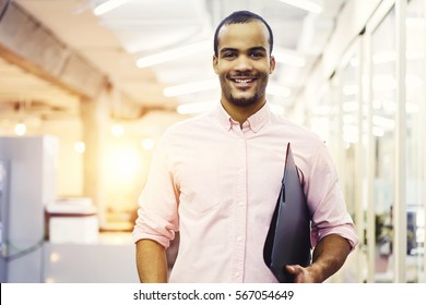 Closeup Portrait Of Cheerful Male Student Got Good Mark For Coursework And Quality Control Testing Feeling Happy To Continue Education In University Waiting For Friends Standing On Blurred Background 