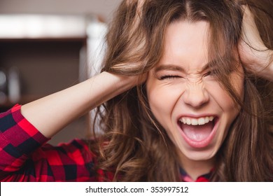 Closeup Portrait Of A Cheerful Woman Touching Her Hair 