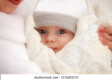 CLoseup Portrait Of Child. Mother Holds On Hands Her Little Baby On Winter Walk Outdoors