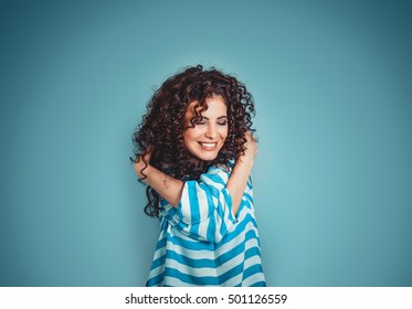 Closeup portrait confident smiling woman holding hugging herself isolated blue wall background. Positive human emotion, facial expression, feeling, reaction, situation, attitude. Love yourself concept