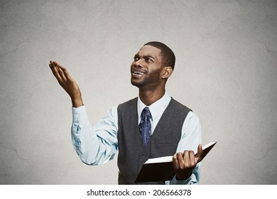 Closeup Portrait Confused, Unhappy Serious Man Holding, Reading  Book, Having Many Questions, Thinking, Isolated Black Background. Human Face Expressions, Emotions, Perception, Body Language, Reaction