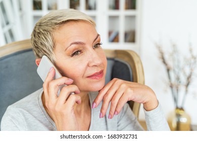 Closeup Portrait Of A Contented Woman With A Stylish Short Haircut Pressing The Phone To Her Ear