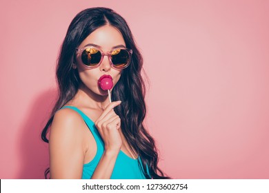 Close-up portrait of cool trendy stylish lovely sweet adorable charming glamorous attractive wavy-haired lady licking yummy sugary lolly pop red lips eyeglasses eyewear isolated over pink background