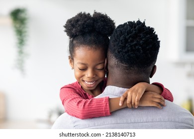 Closeup Portrait Of Curly African American Little Girl Hugging Her Beloved Daddy And Smiling, Happy Black Father And Daughter Spending Time Together At Home, Copy Space, Fatherhood Concept