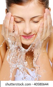 Close-up Portrait Of A Cute Young Woman Wash Her  Face With Water