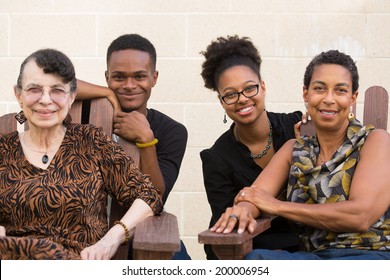 Closeup Portrait, Diverse, Smiling, Multigenerational Family Sitting Down, Isolated Outside Background