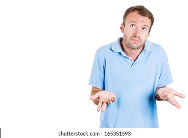 Closeup portrait of dumb clueless young man, arms out asking what's the problem who cares so what, I don't know. Isolated on white background, space to left. Negative human emotion facial expression