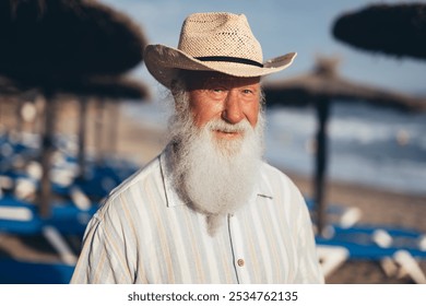 Close-up portrait of an elderly man with a long white beard wear - Powered by Shutterstock