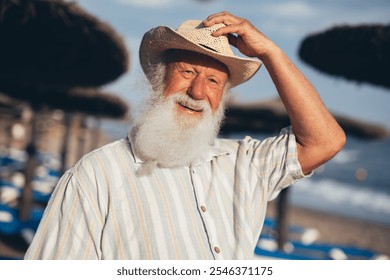 Close-up portrait of an elderly man with a long white beard wear - Powered by Shutterstock