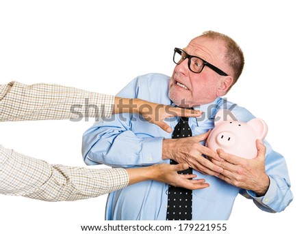 Closeup portrait of elderly, shocked senior business man, grandfather, holding piggy bank, looking scared, trying to protect his savings from being stolen isolated on white background. Financial fraud