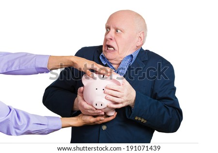Closeup portrait elderly, shocked senior business man, grandfather, holding piggy bank, looking scared trying to protect his savings from being stolen isolated white background. Financial fraud, crime