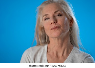 Close-up Portrait Of Excited Amazed Beautiful Mature Woman Send Air Kiss On Solid Blue Color Background